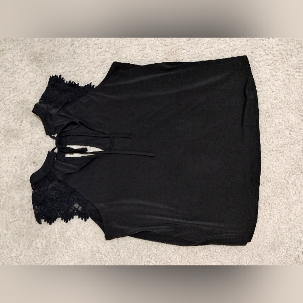 Black top with lacy sleeves and tying in the back